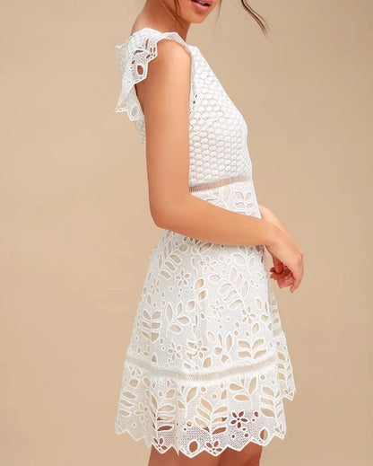 White lace mini dress with cap sleeves and cut-out pattern