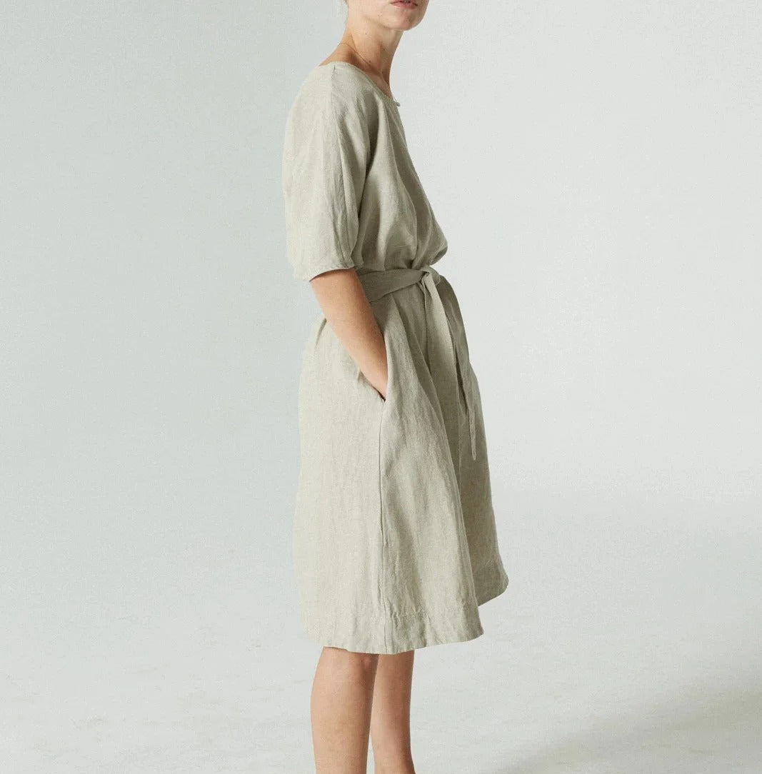 Light green knee-length dress with round neck and tie waist