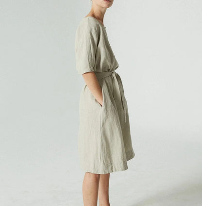 Light green knee-length dress with round neck and tie waist