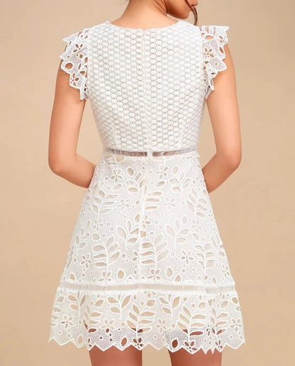 White lace mini dress with cap sleeves and cut-out pattern