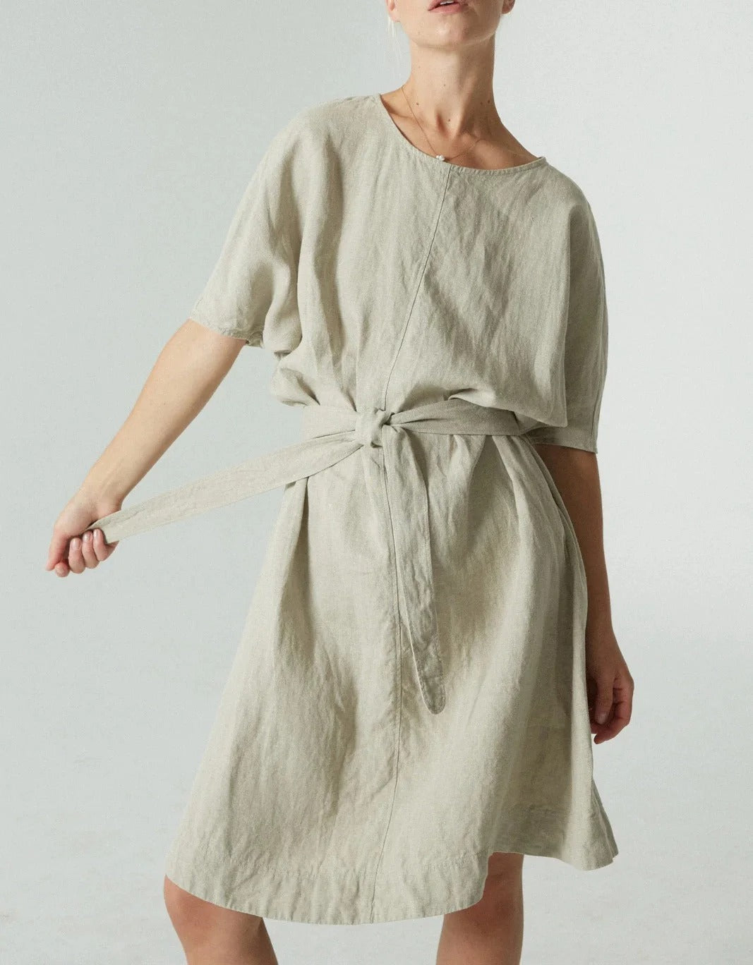 Light green knee-length dress with round neck and tie waist